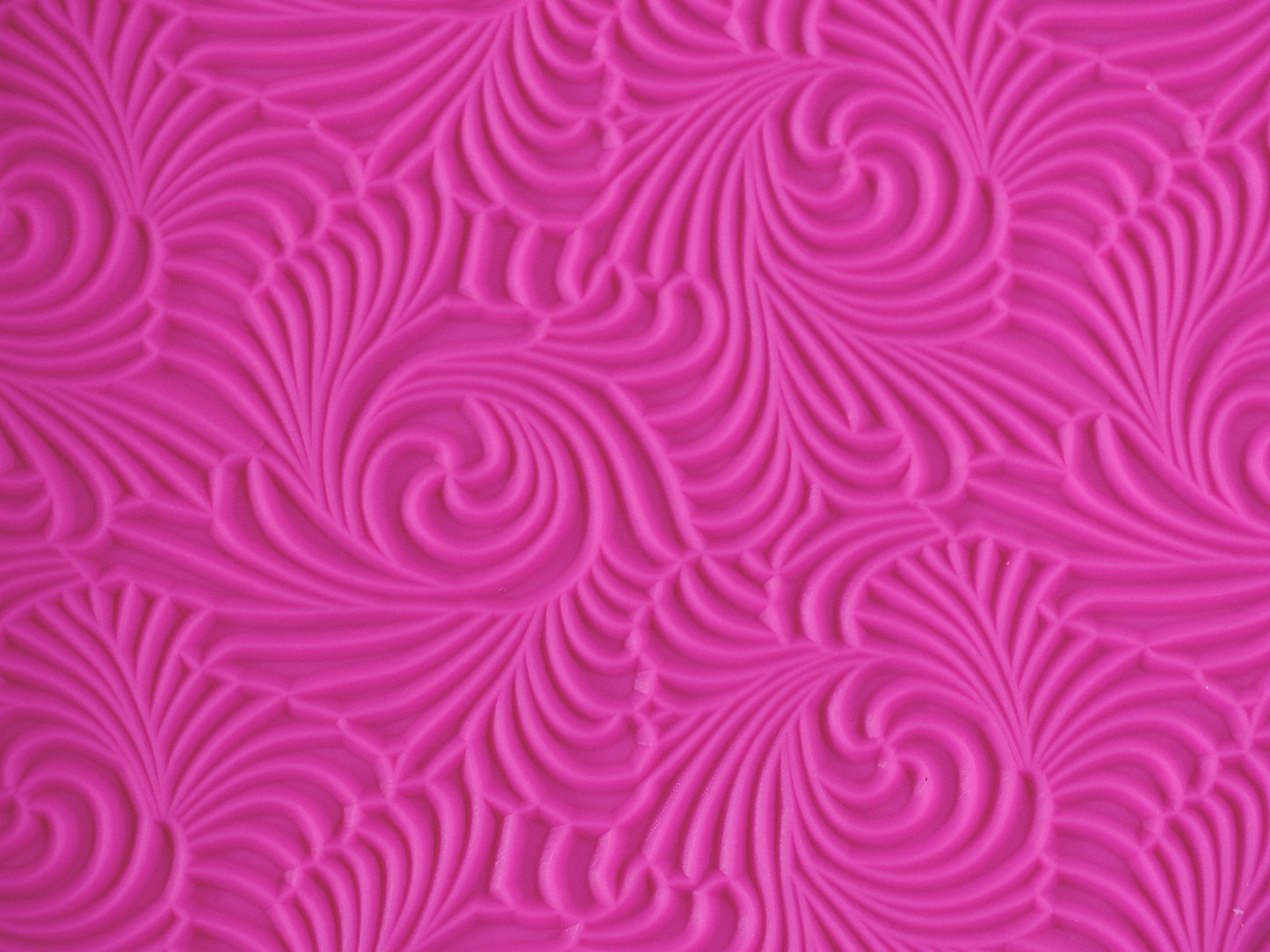 A close up view of the texture on the pink swirl mat.