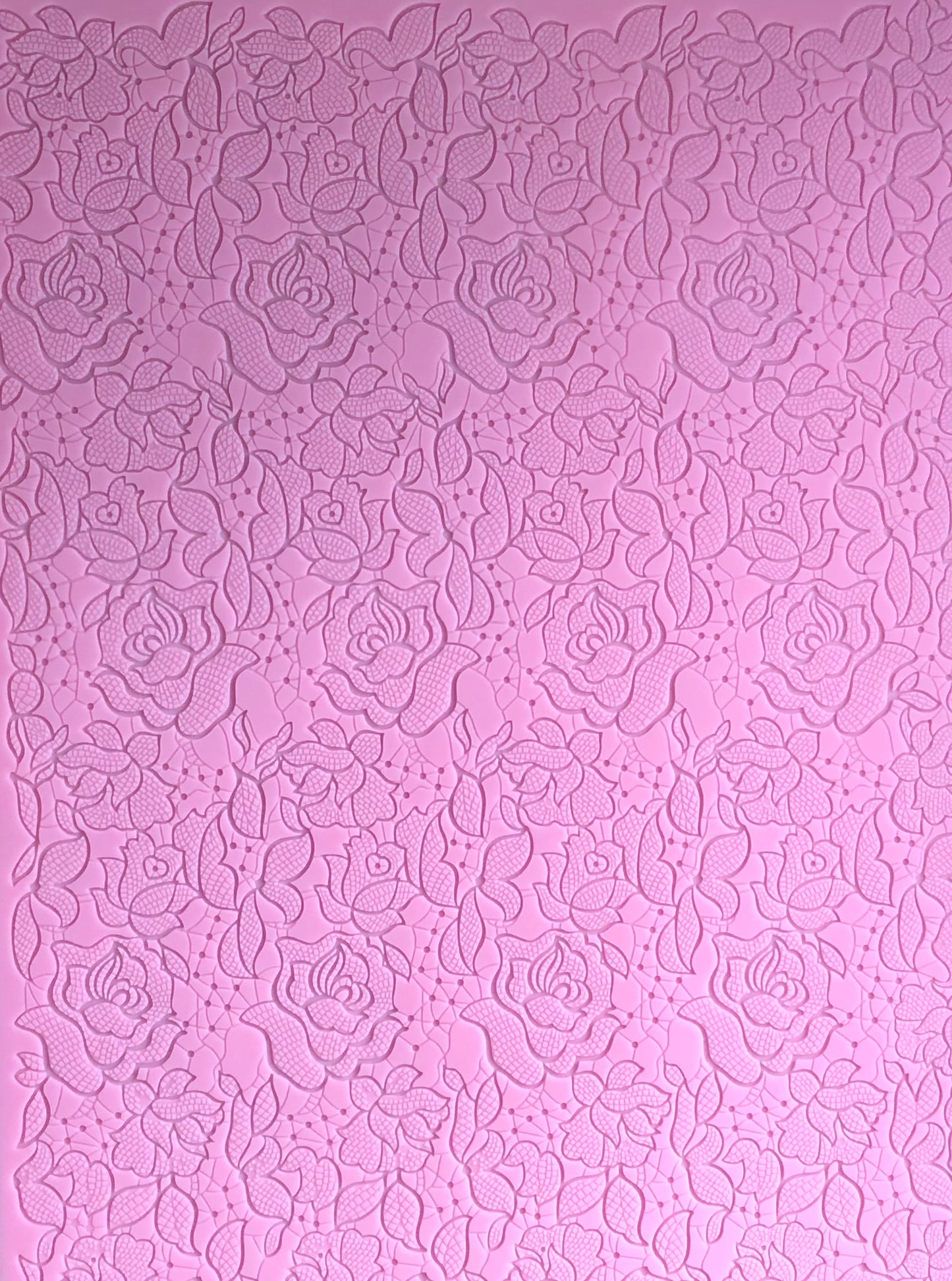 A top view showing the entirety of a textured pink floral design mat.