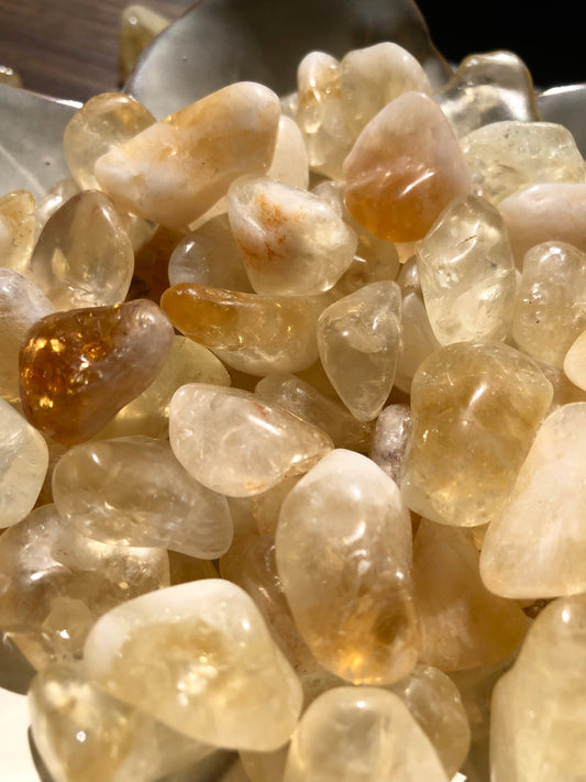 An up close shot of citrine stones. They are various hues of light browns and whites.