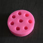 A top view of the black berry mold. The soap mold is pink.