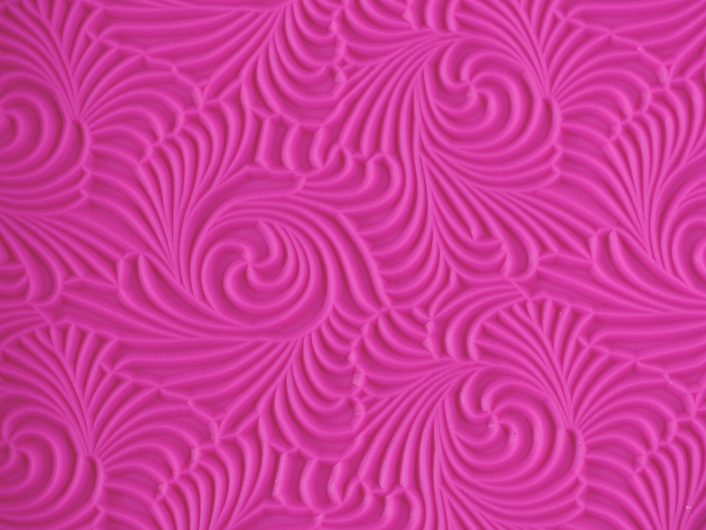 A close up view of the texture on the pink swirl mat.