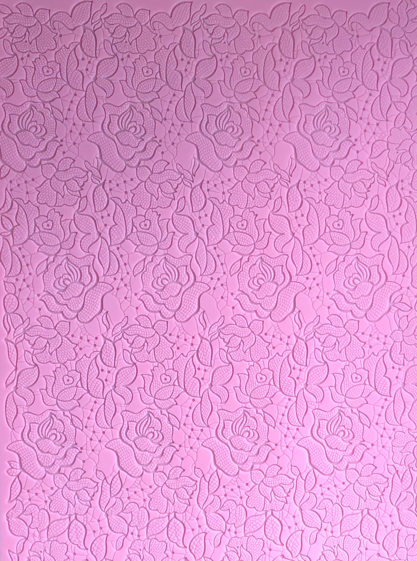 A top view showing the entirety of a textured pink floral design mat.